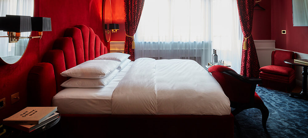 Bellevue Room: King-size bed, armchairs and a couch all red velvet