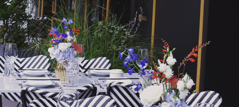 Provocateur Berlin outside seating area with colorful flower decoration