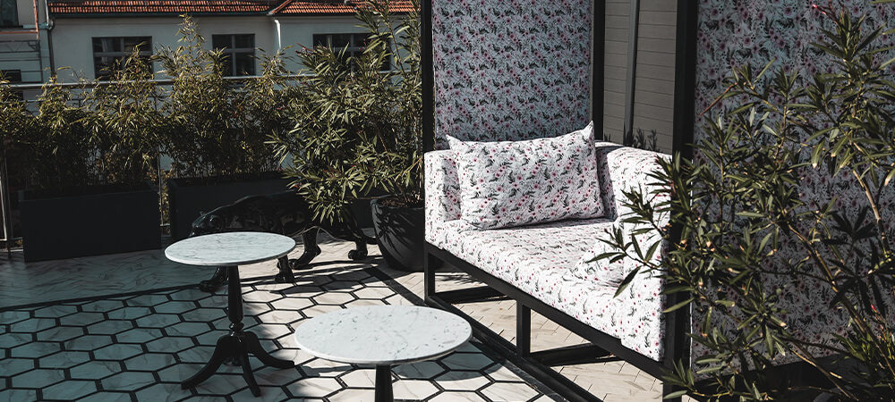 Terrace Suite: white tiled terrace with sofa and tables